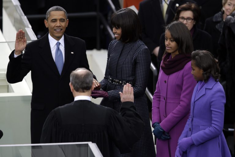 President Barack Obama receives the oath of office from Chief Justice John Roberts as first lady Michelle Obama (L-R) and his daughters Malia and Sasha listen at the ceremonial swearing-in at the U.S. Capitol during the 57th Presidential Inauguration in Washington, Monday, Jan. 21, 2013. (AP Photo/Evan Vucci)