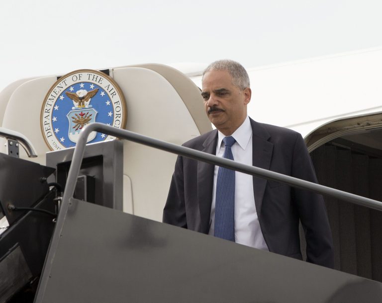 Attorney General Eric Holder arrives on a military aircraft at Lambert-St. Louis International Airport in St. Louis, Wednesday. Holder is traveling to Ferguson, Mo., to oversee the federal government's investigation into the shooting of 18-year-old Michael Brown by a police officer on Aug. 9. (AP Photo/Pablo Martinez Monsivais/Pool)
