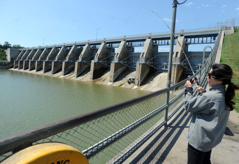   FILE - In this June 13, 2012 file photo Bich Nguyen catches a smallmouth bass at Gavins Point Dam on the Missouri River near Yankton, S.D. North Dakota, South Dakota and Montana, which in the past have brought suits to reduce water being released from dams to boost recreation, are once again battling battling downstream states facing a severe drought and low water levels that threaten commercial traffic along a 180-mile stretch of the Mississippi River between St. Louis and Cairo, Ill. (AP Photo/Argus Leader, Jay Pickthorn, File) NO SALES  