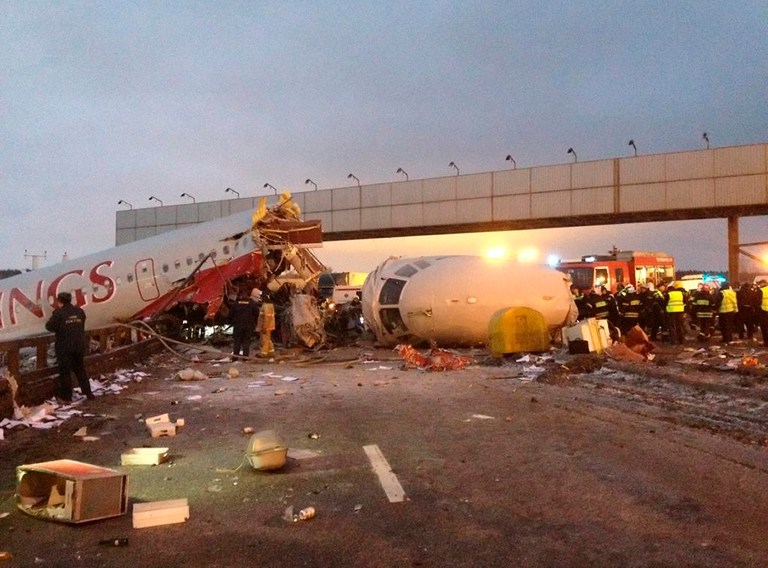   Rescuers work at the site of careered off the runway plane at Vnukovo Airport in Moscow, Saturday, Dec. 29, 2012. A Tu-204 aircraft belonging to Russian airline Red Wings careered off the runway at Russia's third-busiest airport on Saturday, broke into pieces and caught fire, killing several people. (AP Photo/Alexander Usoltsev)  