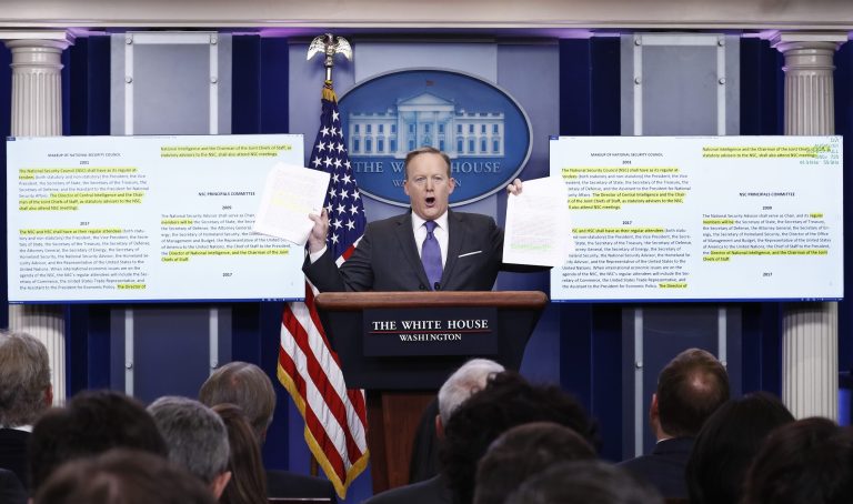 White House press secretary Sean Spicer holds up paperwork about the National Security Council as he speaks during the daily news briefing at the White House in Washington, Monday, Jan. 30, 2017. (AP Photo/Carolyn Kaster)