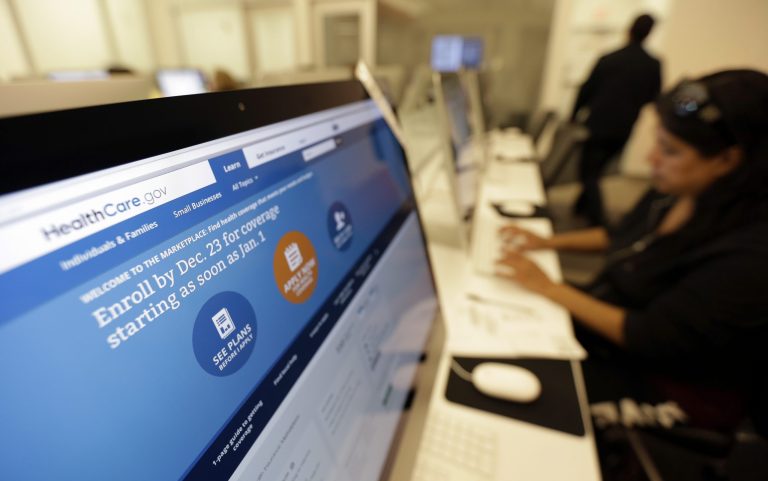 A Texas woman uses a public library computer to access the Affordable Health Care Act website on Dec. 11 in San Antonio. (AP Photo/Eric Gay)