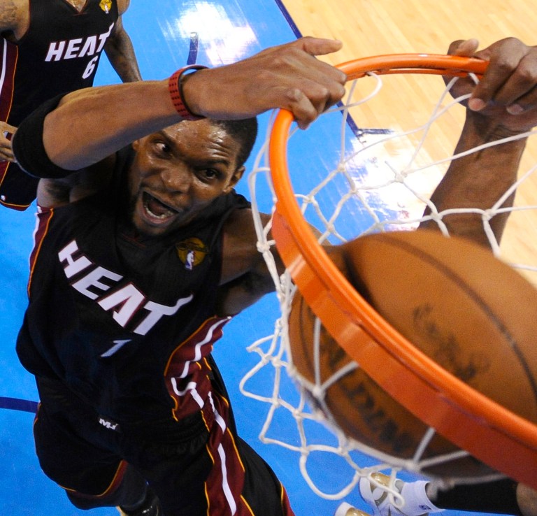   Miami Heat power forward Chris Bosh dunks against the Oklahoma City Thunder during the second half at Game 2 of the NBA finals basketball series, Thursday, June 14, 2012, in Oklahoma City. The Heat won 100-96. (AP Photo/Larry W. Smith, Pool)  