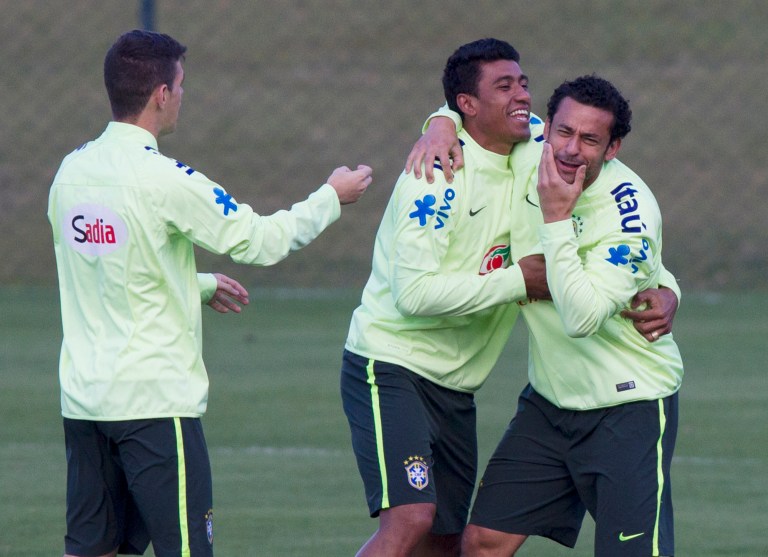 Brazil's soccer players, Fred, right, Paulinho, center and Oscar, joke around during a practice session at the Granja Comary training center, in Teresopolis, Brazil, Sunday, July 6, 2014. Brazil will face Germany on Tuesday in their World Cup semifinals' match, without superstar soccer player Neymar. (AP Photo/Leo Correa)