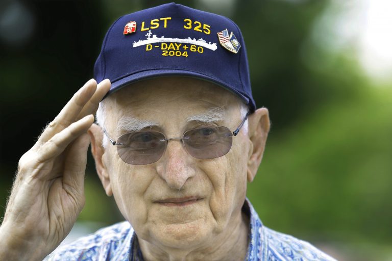 World War II veteran who was at Normandy on D-Day, Emil Kolar, participates in ceremonies to mark the 70th anniversary of the World War II D-Day invasion at Normandy, France, in front of the World War II Memorial at Oak Ridge Cemetery Friday, June 6, 2014, in Springfield, Ill. (AP Photo/Seth Perlman)