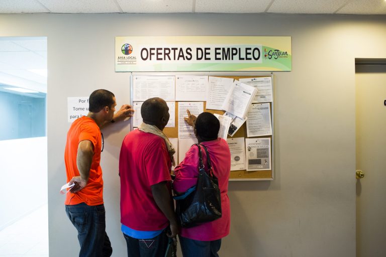 People scan the bulletin board for job postings at the unemployment office on November 14, 2013 in San Juan, Puerto Rico. (Photo by Christopher Gregory/Getty Images)