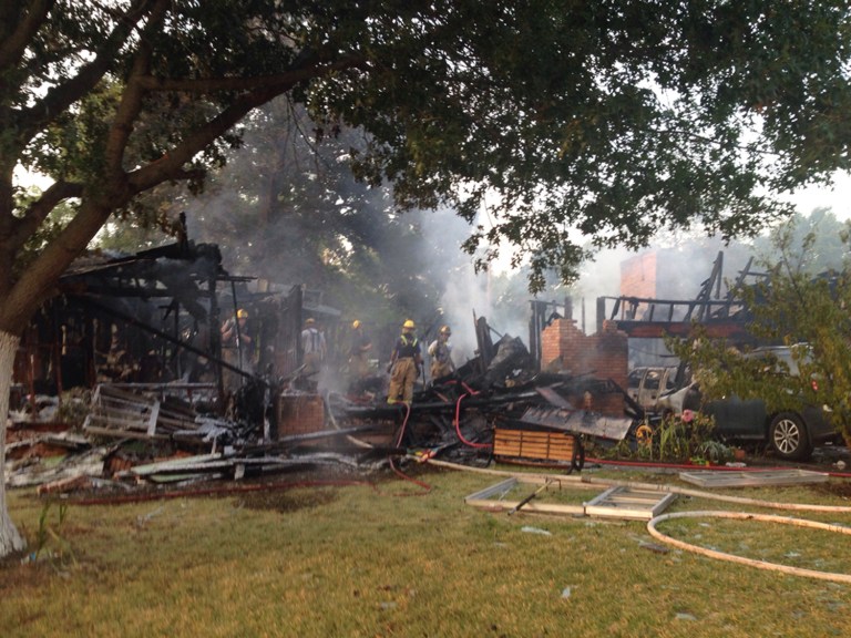 Dallas firemen respond to a one alarm fire early Tuesday, Aug. 26, 2014 in the 1600 block of Champagne drive in Oak Cliff. A gas leak is suspected as the cause of the house explosion in Dallas that injured a woman and her five children. Dallas Fire-Rescue spokesman Joel Lavender told The Dallas Morning News the woman and her children were taken to a hospital with burns. Her injuries appeared to be the most severe. (AP Photo/The Dallas Morning News, David Woo)  MANDATORY CREDIT; MAGS OUT; TV OUT; INTERNET USE BY AP MEMBERS ONLY; NO SALES