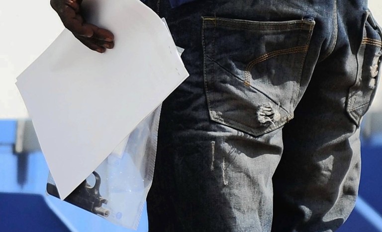 FILE: In this file photo taken Thursday Feb. 14, 2013 a police officer holds a bagged  gun that was allegedly used in the shooting of Reeva Steenkamp, the girlfriend of Olympian athlete Oscar Pistorius, at the Boschkop police station east of Pretoria. Ahead of Pistorius' trial, for the shooting death of his girlfriend Steenkamp, starting Monday, March 3, 2014, legal experts say Pistorius would still be vulnerable to a homIcide conviction even if he is acquitted of murdering Steenkamp.   (AP Photo/Str-File) SOUTH AFRICA OUT