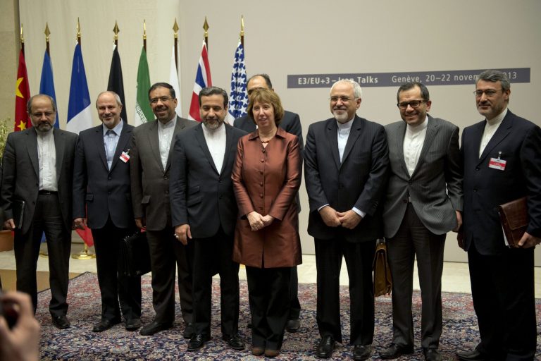 EU High Representative for Foreign Affairs and Security Policy Catherine Ashton, center, poses next to Iranian Foreign Minister Mohammad Javad Zarif, center right,  and the Iranian delegation after a ceremony at the United Nations in Geneva, Switzerland, early  Sunday, Nov. 24, 2013.  Iran struck a historic deal Sunday with the United States and five other world powers, agreeing to a temporary freeze of its nuclear program in the most significant agreement between Washington and Tehran in more than three decades of estrangement. (AP Photo/Keystone,Martial Trezzini)