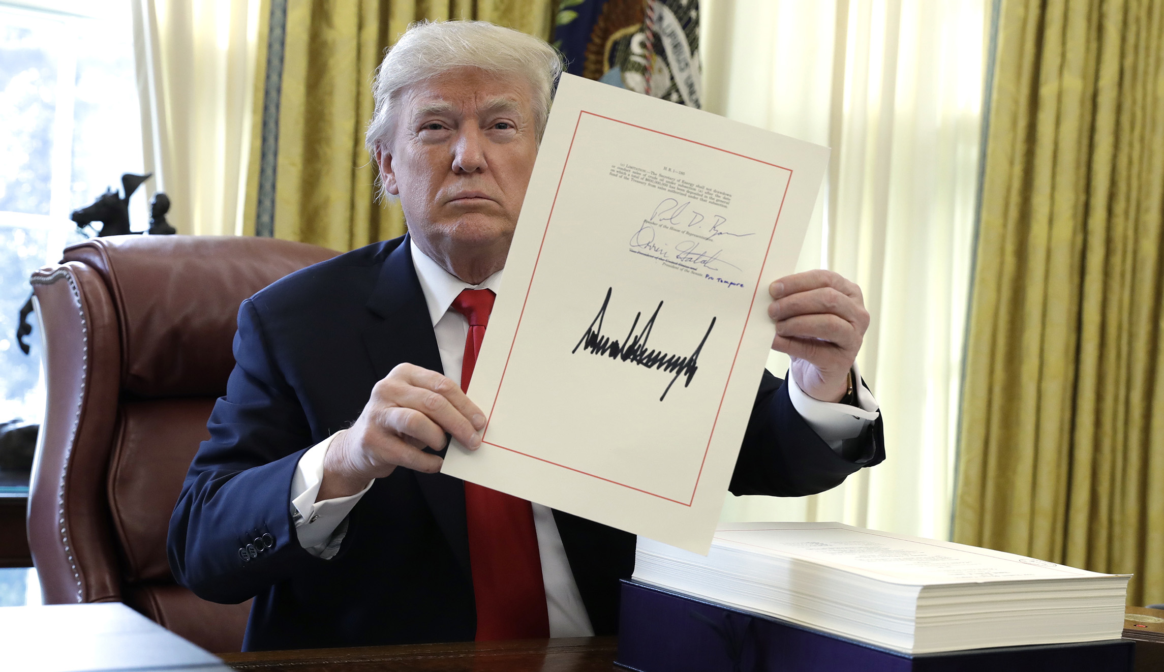 Trump signs tax bill before leaving to spend Christmas at Mar-a-Lago