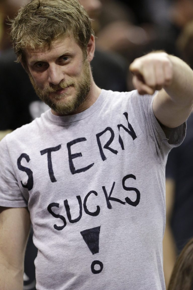   A San Antonio Spurs fan wears a T-shirt with a message in response to the Spurs being fined by NBA Commissioner David Stern for sending four players home to rest, during the first quarter of the Spurs' NBA basketball game against the Memphis Grizzlies, Saturday, Dec. 1, 2012, in San Antonio. (AP Photo/Eric Gay)  