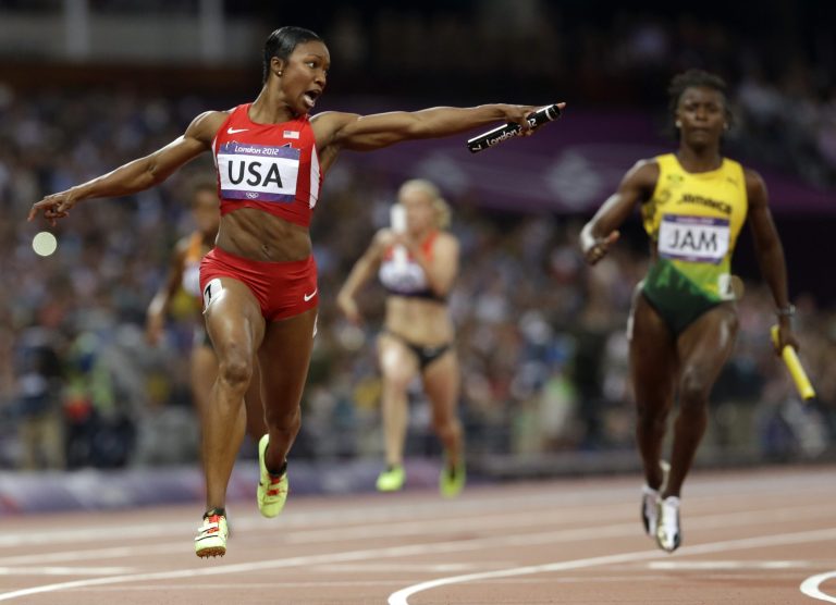 Carmelita Jeter of the United States reacts as she crosses the finish line to win the women's 4 x 100-meter relay during 2012 Summer Olympics. The U.S. team set a new world record with a time of 40.82 seconds.(AP Photo)
