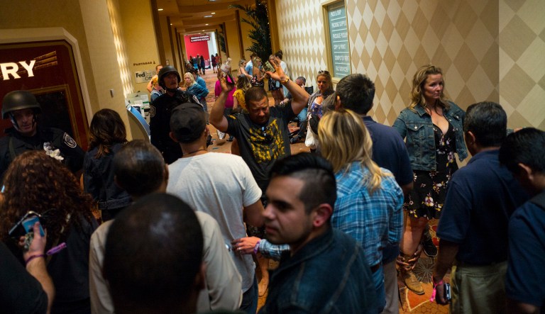 People are searched by Las Vegas police during an active shooter situation on the Las Vegas Strip. Multiple victims were being transported to hospitals after a shooting late Sunday at a music festival on the Las Vegas Strip. (Chase Stevens/Las Vegas Review-Journal via AP)