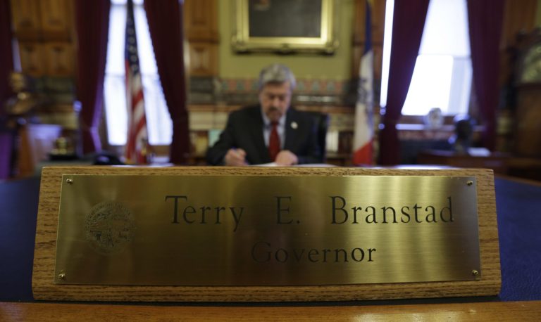   In this Dec. 19, 2012 photo, Iowa Gov. Terry Branstad works in his office at the Statehouse in Des Moines, Iowa. Iowa is one of only three states where control of the legislature is split between the parties. Instead of laying out bold initiatives for overhauling taxes or education, Branstad and legislative leaders are trying to figure out a few things they can agree on so that when the session is over, they won't wind up with nothing. (AP Photo/Charlie Neibergall)  