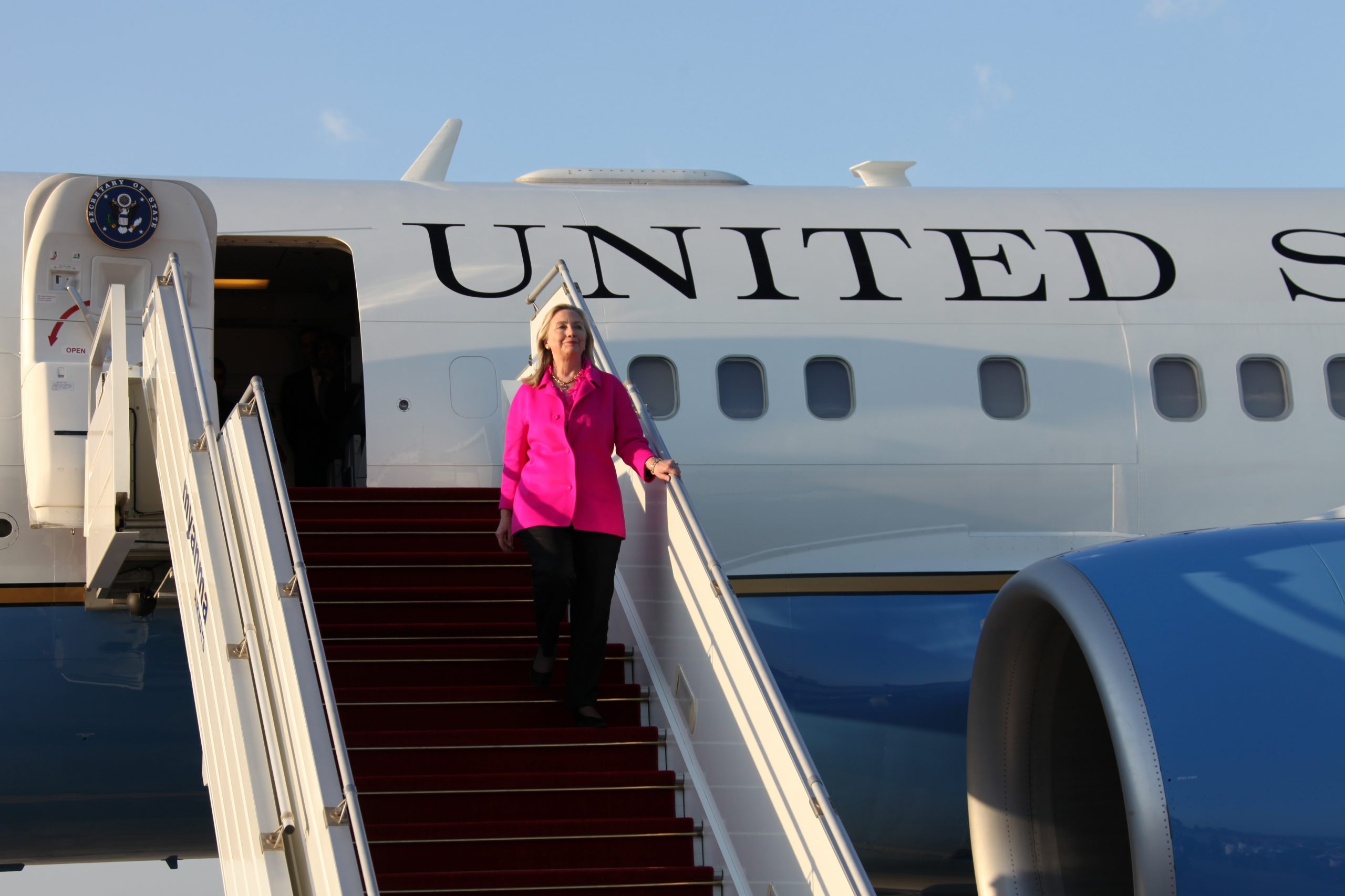 Clinton Strains to Greet Media Aboard Plane