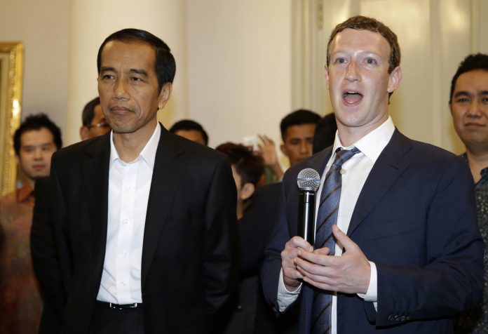 Facebook CEO Mark Zuckerberg, right, speaks during a joint press conference with Indonesian President-elect Joko Widodo, left, after their meeting in Jakarta, Indonesia, Monday, Oct. 13, 2014. Zuckerberg and Widodo discussed ways to take advantage of the online social networking service for beneficial of national development. (AP Photo/Achmad Ibrahim)