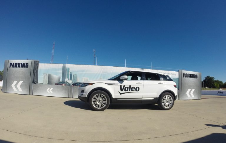 A Range Rover drives by itself toward a parking spot during a demonstration by Valeo on Sept. 8, 2014, in Detroit. Technology being honed by the French auto parts maker uses a dozen ultrasonic sound-wave sensors, 360-degree cameras and a laser scanner to allow a vehicle to safely park within a few centimeters of other vehicles. (AP Photo/Mike Householder)