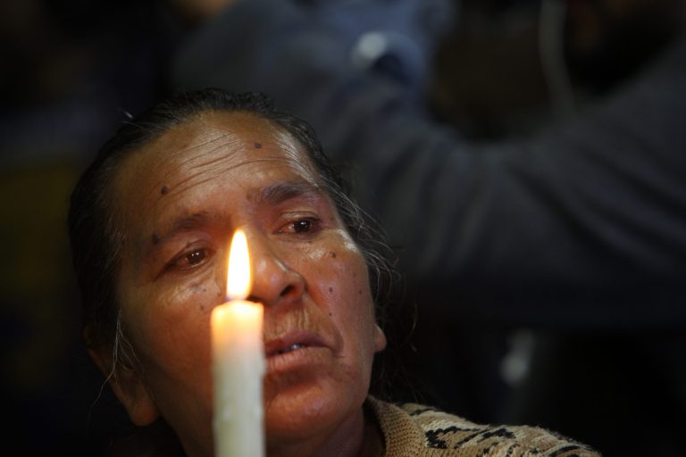 A mother of one of 43 missing students from the Isidro Burgos rural teachers college attends a mass at the Basilica of Guadalupe in Mexico City, Sunday, Oct. 19, 2014. Investigators determined that 28 sets of human remains recovered from a mass grave discovered last weekend outside Iguala, in Guerrero state, were not those of any of the youths who haven't been seen since being confronted by police in that city Sept. 26. (AP Photo/Marco Ugarte)