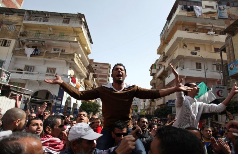 Egyptian protesters chant angry slogans during a demonstration after the noon prayer in Port Said, Egypt, Friday, March 8, 2013. With the country in chaos from weeks of protests against the Islamist president, the police have now joined the fray, launching their own protests. Some security forces in Port Said have refused to leave their barracks to move against protesters in the street amid clashes raging for days. Others have refused orders to deploy to Port Said from elsewhere to help in the fight. (AP Photo/Khalil Hamra)