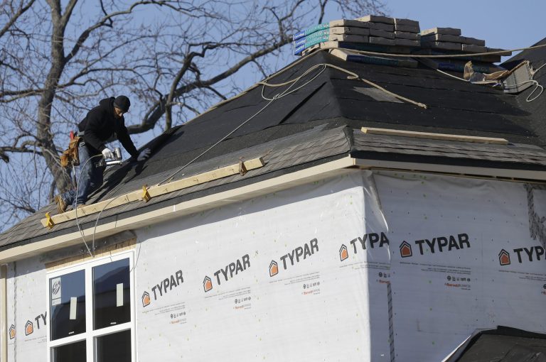 In this Friday, Dec. 27, 2013, photo, a construction worker builds a new home in Wilmette, Ill. The Commerce Department releases new home sales for December on  Monday, Jan. 27, 2014. (AP Photo/Nam Y. Huh)