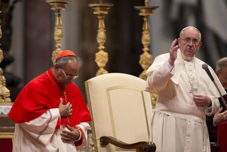 Pope Francis, right,  delivers his blessing flanked by Cardinal Albert Malcolm Ranjith, of Sri Lanka, after a mass for the Sri lankan community in St. Peter's Basilica at the Vatican, Saturday, Feb. 8, 2014. (AP Photo/Alessandra Tarantino)