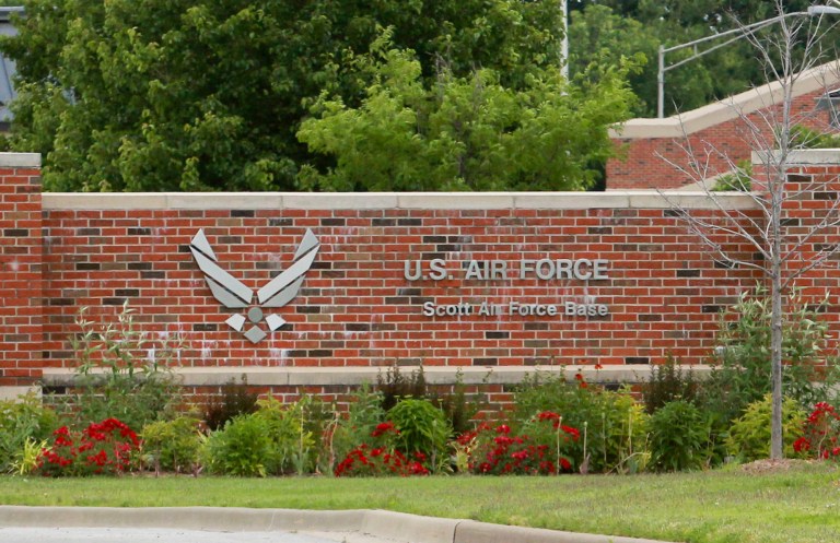This June 10, 2013 photo shows the main entrance to Scott Air Force Base near Mascoutah, Ill.  The addition of two cybersecurity squadrons to the Air Force base in southwestern Illinois will bring 320 new jobs within two years and a $16 million investment in the site, members of Illinois' congressional delegation announced Wednesday, June 25, 2014. Scott Air Force Base and another in Texas won the competition among seven finalists for the protection squads, which guard against attacks on the nation's computer networks, identify hackers, stop the attacks and fix the damage. (AP Photo/Belleville News-Democrat, Derik Holtmann)