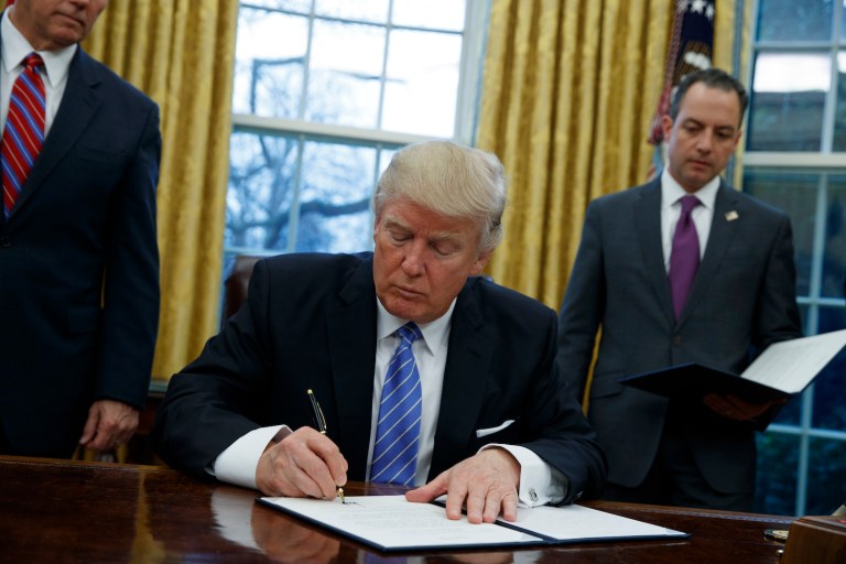 Trump also reportedly signed a federal hiring freeze for all departments except the military. (AP Photo/Evan Vucci)
