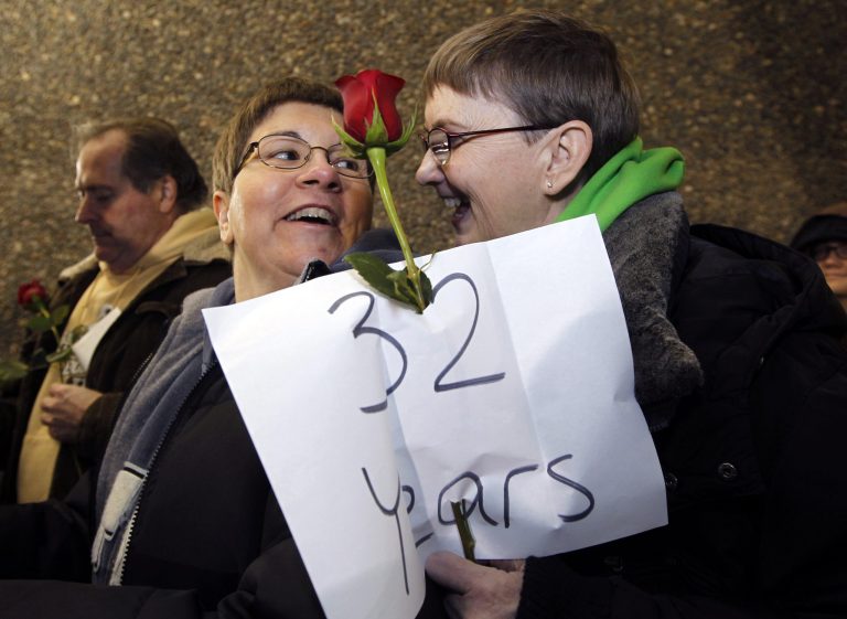   Melody Platt, left, and her partner Beratta Gomillion wait among the first couples in line to be issued a marriage license to a same-sex couple, Wednesday, Dec. 5, 2012, in Seattle. King County Executive Dow Constantine was to began issuing the licenses just after midnight, Thursday, Dec. 6, immediately upon certification of the November election that passed Referendum 74 allowing same-sex couples to wed. The couple are planning on getting married on their 32nd anniversary, Monday Dec. 12. (AP Photo/Elaine Thompson)  