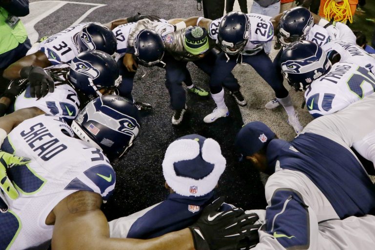 The Seattle Seahawks huddle before the NFL Super Bowl XLVIII football game against the Denver Broncos Sunday, Feb. 2, 2014, in East Rutherford, N.J. (AP Photo/Julio Cortez)
