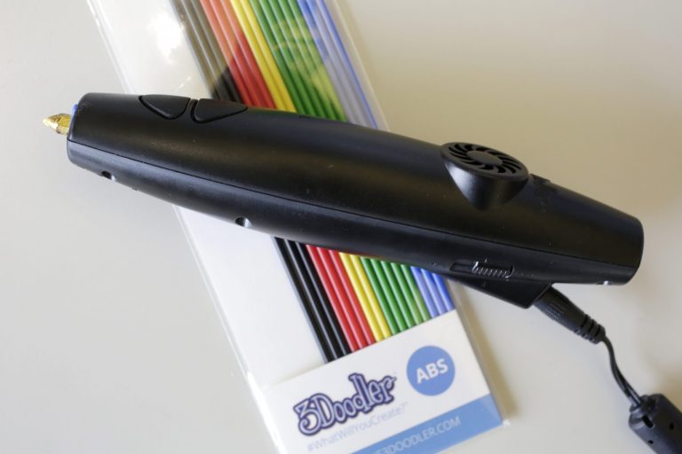 A 3Doodler pen and a packet of plastic sticks are arranged for a photo, Tuesday, July 29, 2014 in New York. A plastic stick goes in one end of the glue gun-like device and comes out, melted, at the tip. As you move your hand, it leaves a thin trail of cooling, solidifying plastic. Move it around with a plan, laying down string upon string, and things start taking shape.  (AP Photo/Mark Lennihan)
