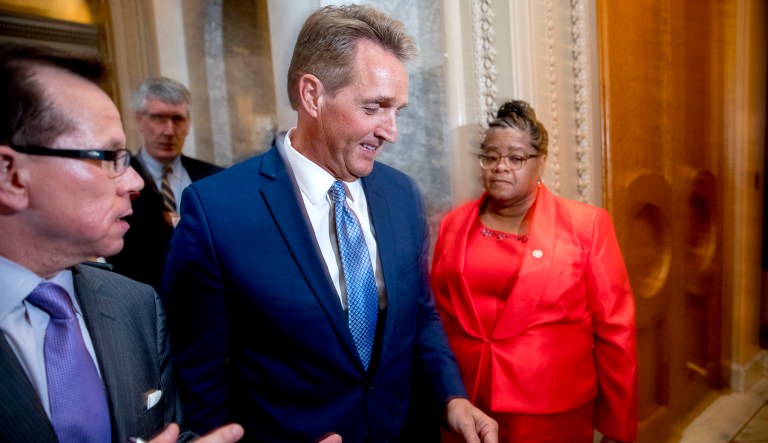 Sen. Jeff Flake, R-Ariz., walks on to the Senate floor on Capitol Hill in Washington, Tuesday, Oct. 24, 2017, after announcing he won't seek re-election in 2018. (AP Photo/Andrew Harnik)
