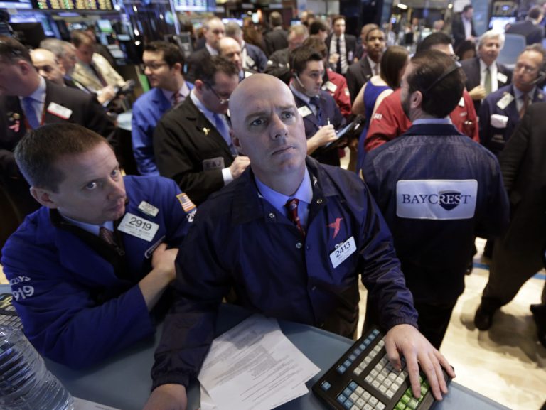 Specialists Robert Nelson, left, and John O'Hara work on the floor of the New York Stock Exchange. (AP Photo/Richard Drew)