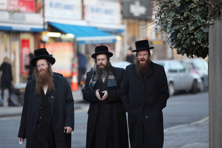 Hasidic Jewish men walk along the street in the Stamford Hill area of north London on Jan. 19, 2011 in London, England. The small village of Bloomingburg, N.Y., could soon become a community for ultra-orthodox Hasidic Jews. (Photo by Oli Scarff/Getty images)