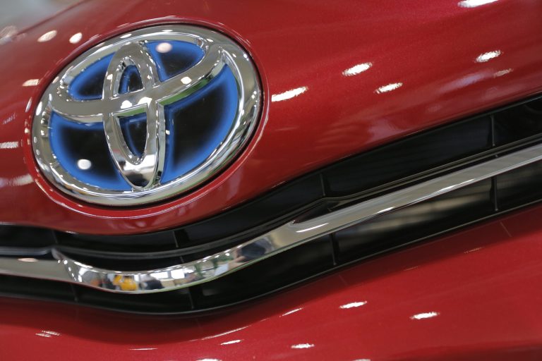 FILE - In this Aug. 2, 2013 file photo, the emblem of a Toyota car shines at Toyota Motor Corp.'s showroom Toyota Mega Web in Tokyo. Toyota Motor Corp. is recalling 6.39 million vehicles globally for a variety of problems spanning nearly 30 models in Japan, the U.S., Europe and other places. No injuries or crashes have been reported related to the recalls announced Wednesday, April 9, 2014. But two fires have been reported related to one of the problems, a defective engine starter that can keep the motor running. (AP Photo/Itsuo Inouye, File)
