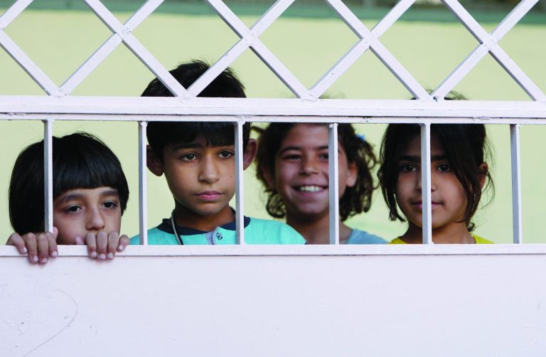 Syrian children, who fled their homes with their families due to fighting between Syrian rebels and government forces, take refuge at the Samiya al-Makhzumi school in Mezzeh neighborhood, in Damascus, Syria, Sunday, Sept. 16, 2012. Many Syrians who have fled violence in their country are living near the border but outside the dozen camps, either staying with relatives, renting apartments, and in some cases take refuge at schools. The influx since the uprising against Syrian President Bashar Assad began 18 months ago has raised concerns about sectarian tension and militant activity in the region. (AP Photo/Muzaffar Salman)