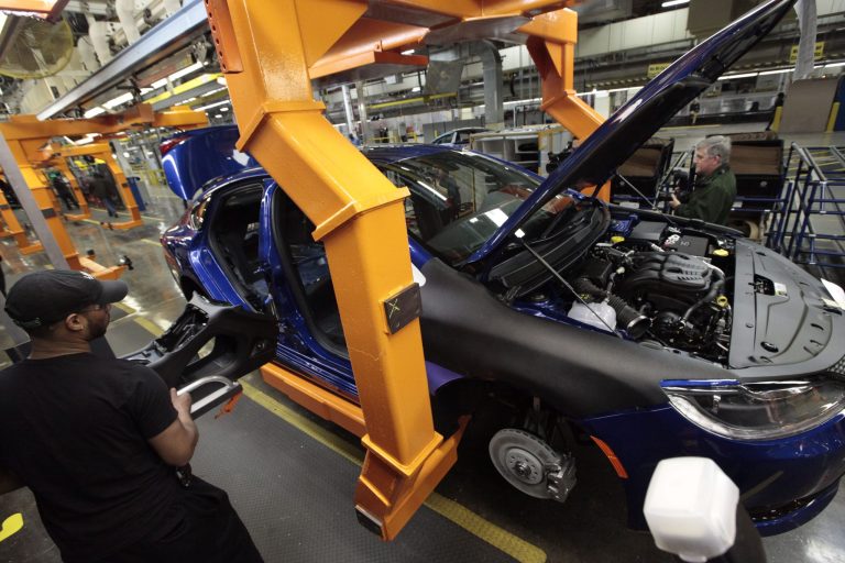 In this March 14, 2014 photo, an assembly line worker builds a 2015 Chrysler 200 automobile at the Sterling Heights Assembly Plant in Sterling Heights, Mich. Chrysler Group LLC reports quarterly earnings on Monday, May 12, 2014. 