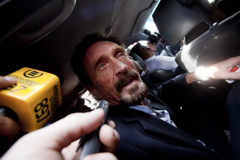   Software company founder John McAfee leaves an migration detention center for the La Aurora international airport in Guatemala City, Wednesday Dec. 12, 2012. McAfee was released from detention in Guatemala and is being deported to the U.S. McAfee was detained last week for immigration violations after he sneaked into Guatemala from neighboring Belize, where authorities sought to question him about the murder of his neighbor. (AP Photo/Moises Castillo)  