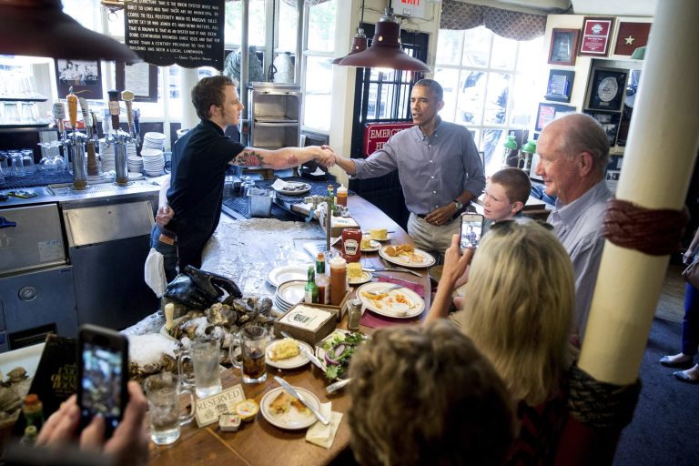 Greets people at Ye Olde Union Oyster House, Monday, Sept. 7, 2015, in Boston. Obama signed an executive order requiring federal contractors to offer their employees up to seven days of paid sick leave per year. (AP Photo/Andrew Harnik)