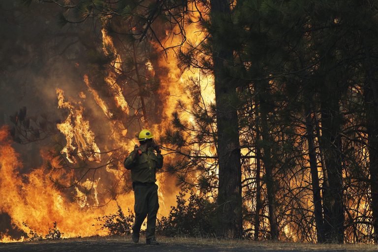 FILE - This Aug. 25, 2013 file photo shows firefighter A.J. Tevis watching the flames of the Rim Fire near Yosemite National Park, Calif.  The House has approved a wide-ranging bill that speeds logging of trees burned in last year's massive Rim Fire in California. The measure also allows vehicular access to North Carolina's Cape Hatteras National Seashore, extends livestock grazing permits on federal land in the West and lifts longstanding restrictions on canoes, rafts and other 