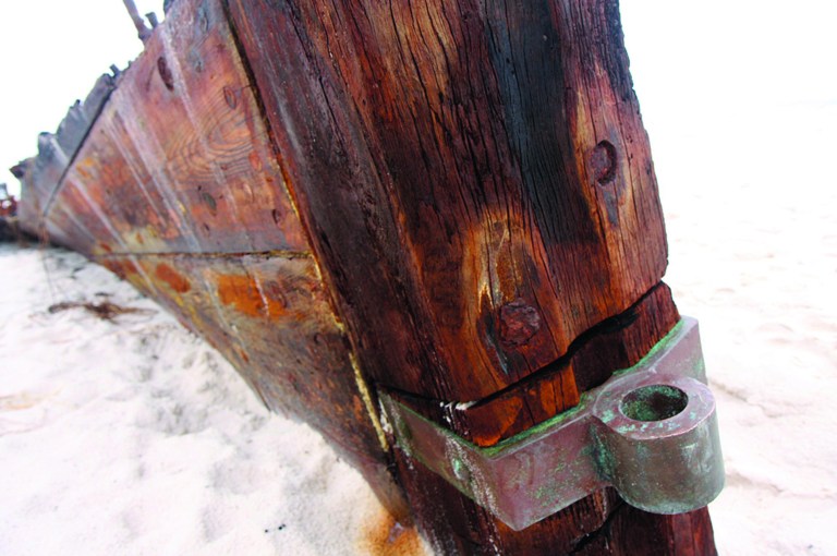 In this Wednesday, Sept. 5, 2012 photo, the remains of an old wooden ship rest along a private beach at Fort Morgan, Ala. The ship is the Rachel, a schooner built in Pascagoula, Miss., during World War I, according to Mike Bailey, historian with the Fort Morgan Historical Society. The ship was lost in a storm in 1923. The remains of the the Rachel have been uncovered by hurricanes in the past, but more of the wreck was revealed in the wake of Hurricane Isaac. (AP Photo/Press-Register, Brian Kelly) MAGS OUT