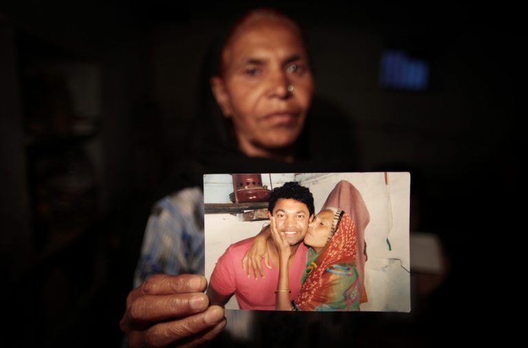   In this May 10, 2012 photo, Fatima Munshi, mother of Saroo, holds up a photo from their reunion in February 2012 at her home in Khandwa, India. Living in Australia, Saroo Brierley, 30, was reunited with his biological mother, Munshi, 25 years after an ill-fated train ride left him an orphan on the streets of Calcutta. (AP Photo/Saurabh Das)  
