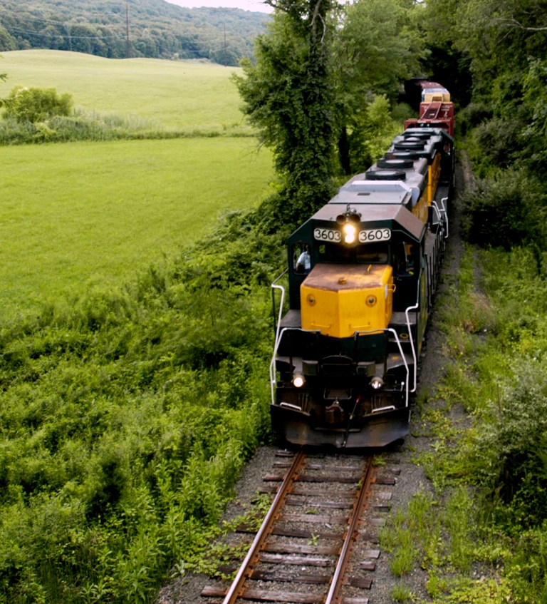 In this Aug. 8, 2008 photo, a Housatonic Railroad freight train heads north through scenic terrain along Middle Road in New Milford, Conn. Elected officials, regional business owners and the owner of New England Central Railroad are lobbying federal transportation officials in 2014  to upgrade the state's railroad tracks to accommodate heavier freight. (AP Photo/The News-Times, Norm Cummings) MANDATORY CREDIT.