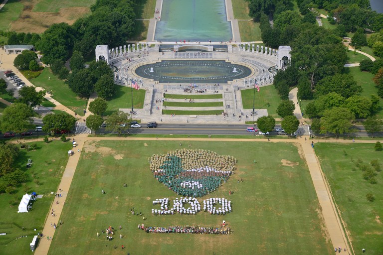 People on the National Mall in Washington created a giant, living version of the National Park Service emblem. (Tim Ervin/National Park Service via AP)