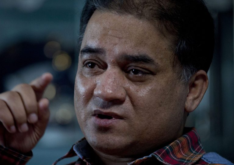 In this Feb. 4, 2013 photo, Ilham Tohti, an outspoken scholar of China's Turkic Uighur ethnic minority, speaks during an interview at his home in Beijing, China. Tohti was set to go on trial on Wednesday, Sept. 17, 2014 on separatism charges in the country's far western region of Xinjiang. (AP Photo/Andy Wong)