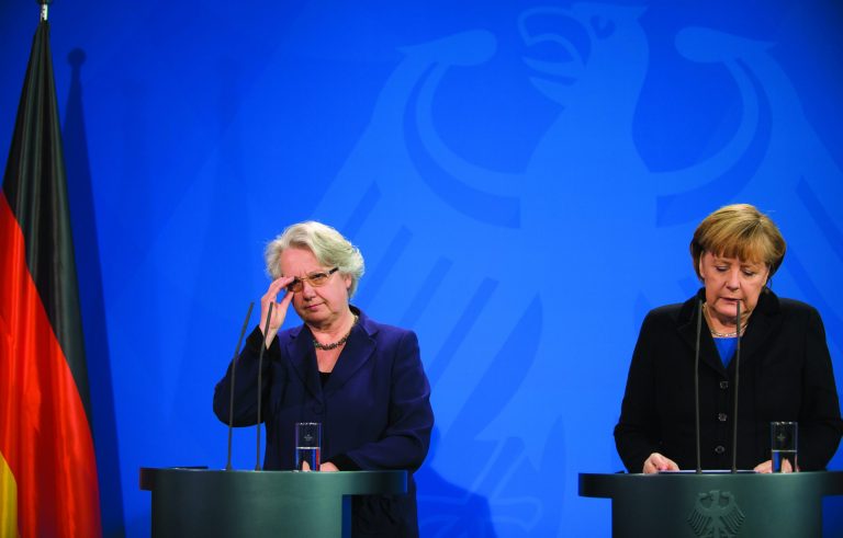 German chancellor Angela Merkel , right, and education minister Annette Schavan, left, address the press in Berlin Saturday, Feb. 9, 2013. Germany's education minister has resigned after a university decided to withdraw her doctorate, finding that she plagiarized parts of her thesis - an embarrassment for Chancellor Angela Merkel's government months before national elections. (AP Photo/dpa, Wolfgang Kumm)