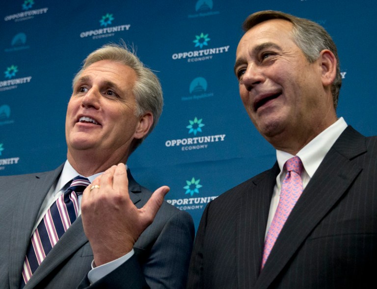 House Majority Leader Kevin McCarthy of Calif. gestures toward outgoing House Speaker John Boehner of Ohio during a new conference on Capitol Hill. The House of Representatives passed a budget bill Wednesday. (AP Photo/Carolyn Kaster)