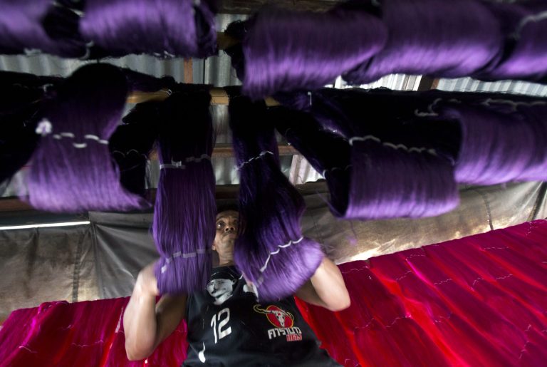 A Thai worker adjusts batches of dried silk thread after it was dyed in Bangkok on Thursday, July 31, 2014. A surge in silk yarn prices has attracted more silk farmers in the last two years, according to the Queen Sirikit Department of Sericulture.  Most Thai silk is used in the domestic market but plans are afoot to increase production.  (AP Photo/Sakchai Lalit) (AP Photo/Sakchai Lalit)