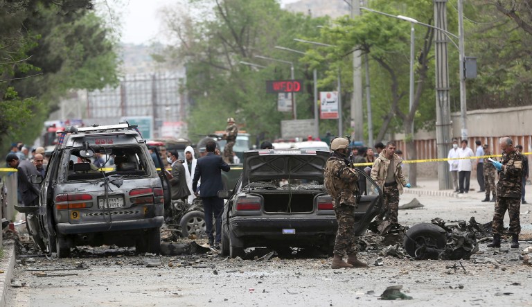 Security forces inspect the site of a suicide attack in Kabul, Afghanistan. 