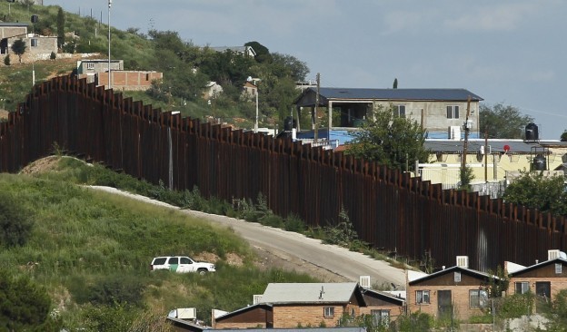 A U.S. Border Patrol vehicle keeps watch along the border fence in Nogales, Ariz. (Ross D. Franklin/AP)