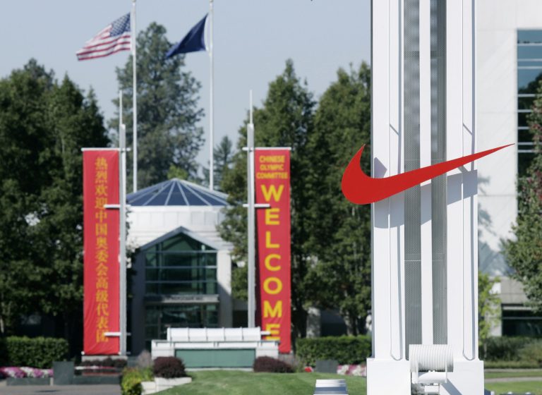   FILE - In this Sept. 29, 2006 file photo, the red Nike swoosh marks the entrance to the company's headquarters campus in Beaverton, Ore. Nike wants to expand its Oregon operations and hire as many as 12,000 new workers by 2020 but wants the government to promise it won't change the state tax code. Oregon Gov. John Kitzhaber says he'll call the Legislature into session Friday to create a law to give Nike its promise. (AP Photo/Don Ryan, File)  